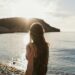 back view of woman looking into sea